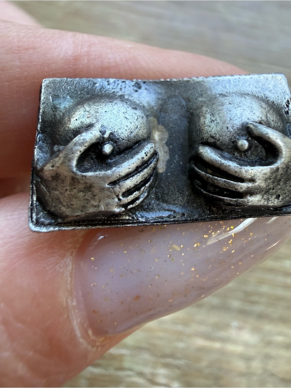Vintage tie clip with two hands holding breasts design